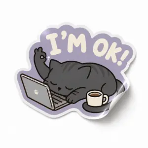 I’m OK Cat Sticker — Coffee & Code design on a white background with a lifted corner