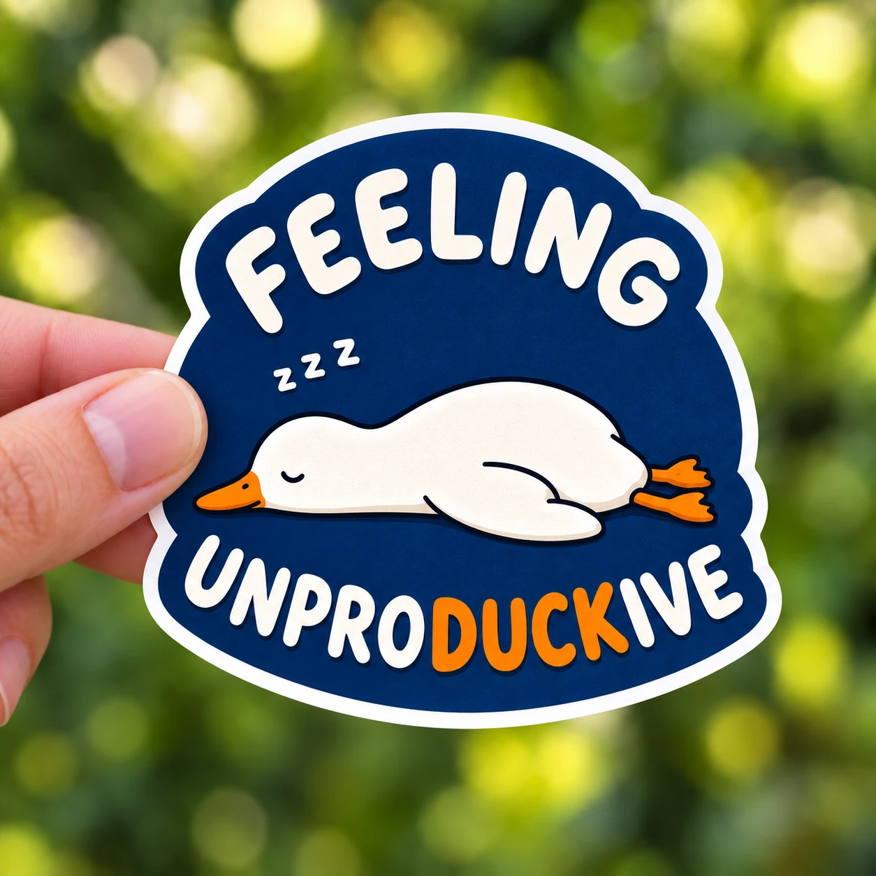 Feeling Unproductive Duck Sticker, Navy Nap design shown held in a hand