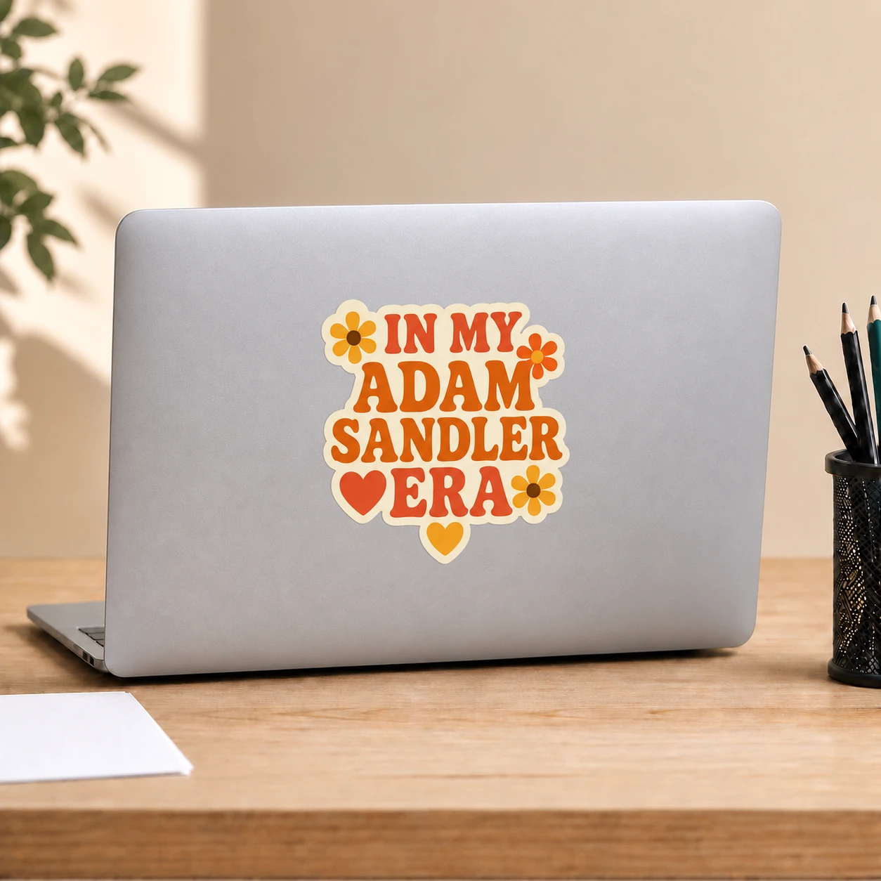 In My Adam Sandler Era Sticker, Retro Flowers design shown on a laptop lid