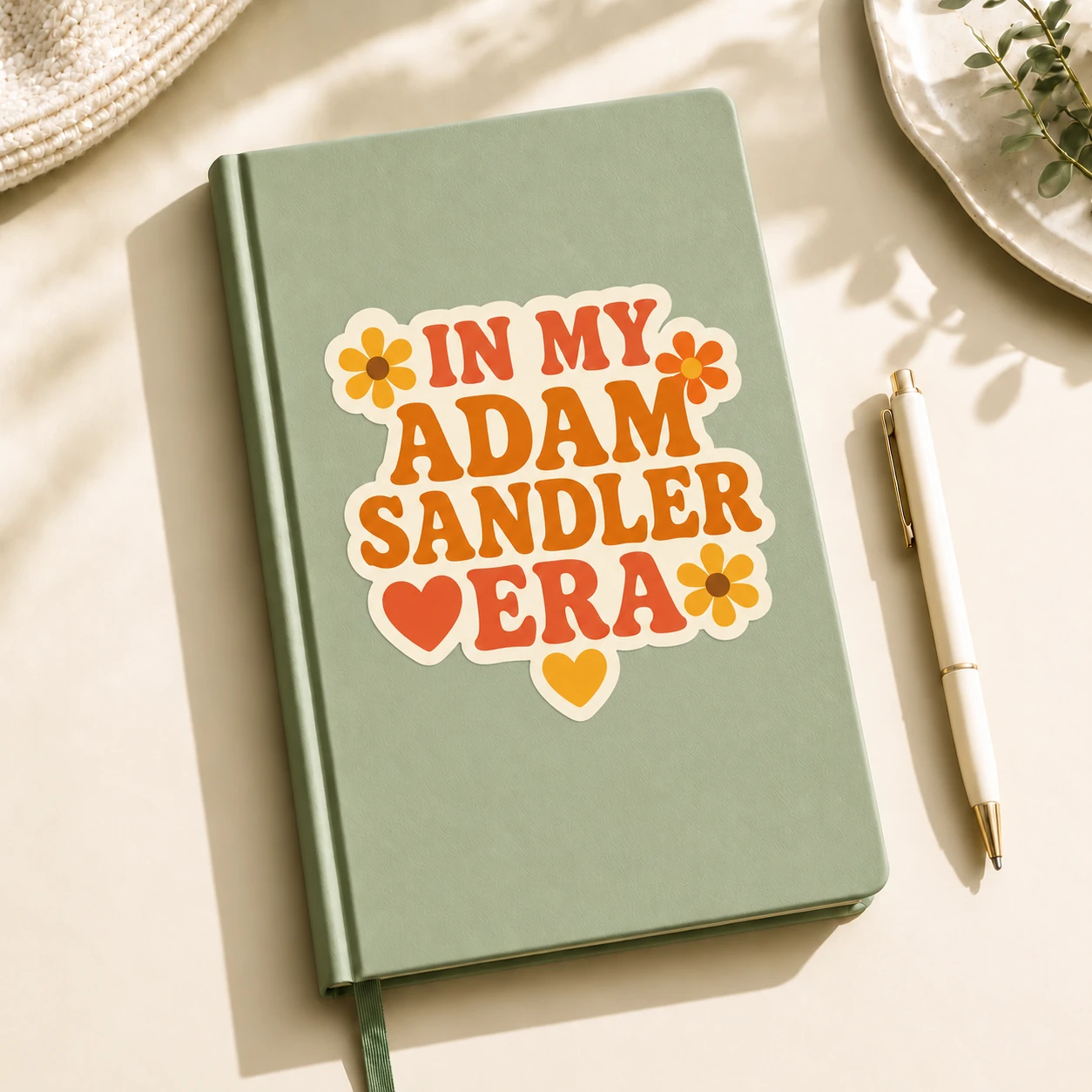 In My Adam Sandler Era Sticker, Retro Flowers design shown on a notebook