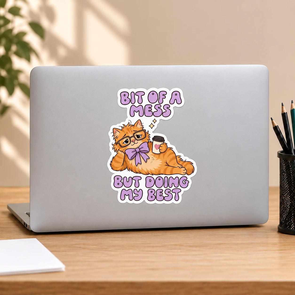 Bit of a Mess Sticker, Coffee Cat design shown on a laptop lid