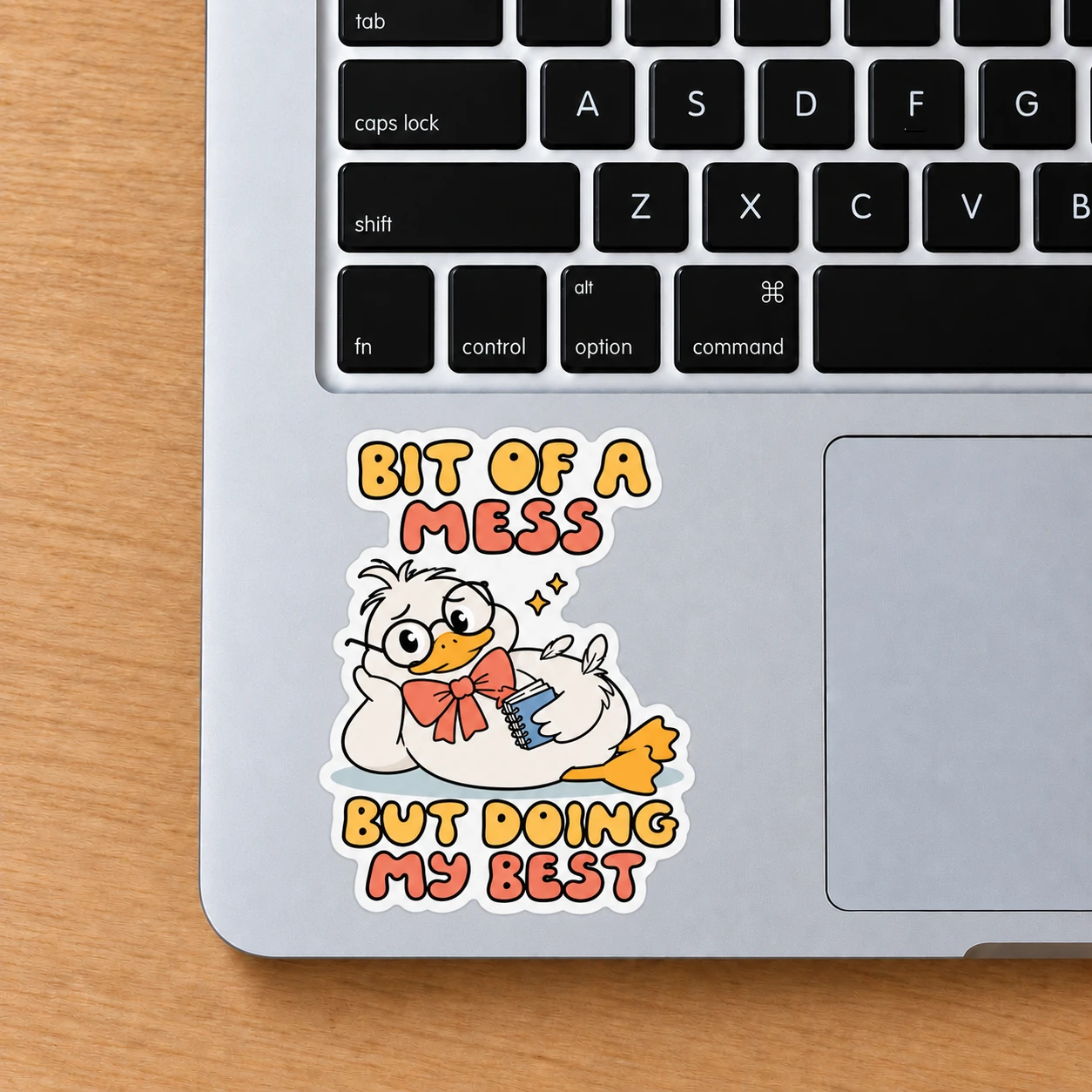 Bit of a Mess Sticker, Notebook Duck design shown on a laptop palm rest