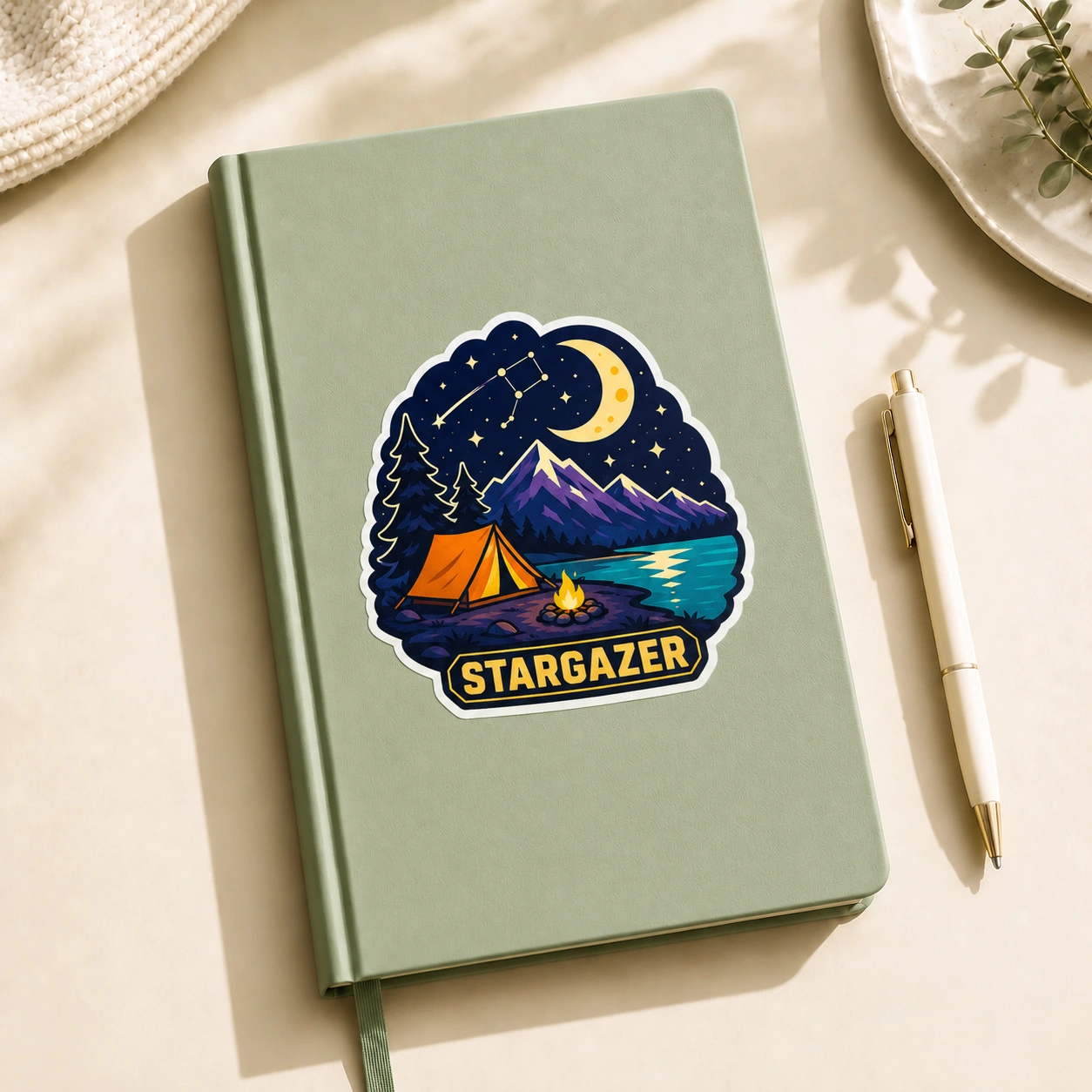 Starry Adventures Sticker, Stargazer design shown on a notebook