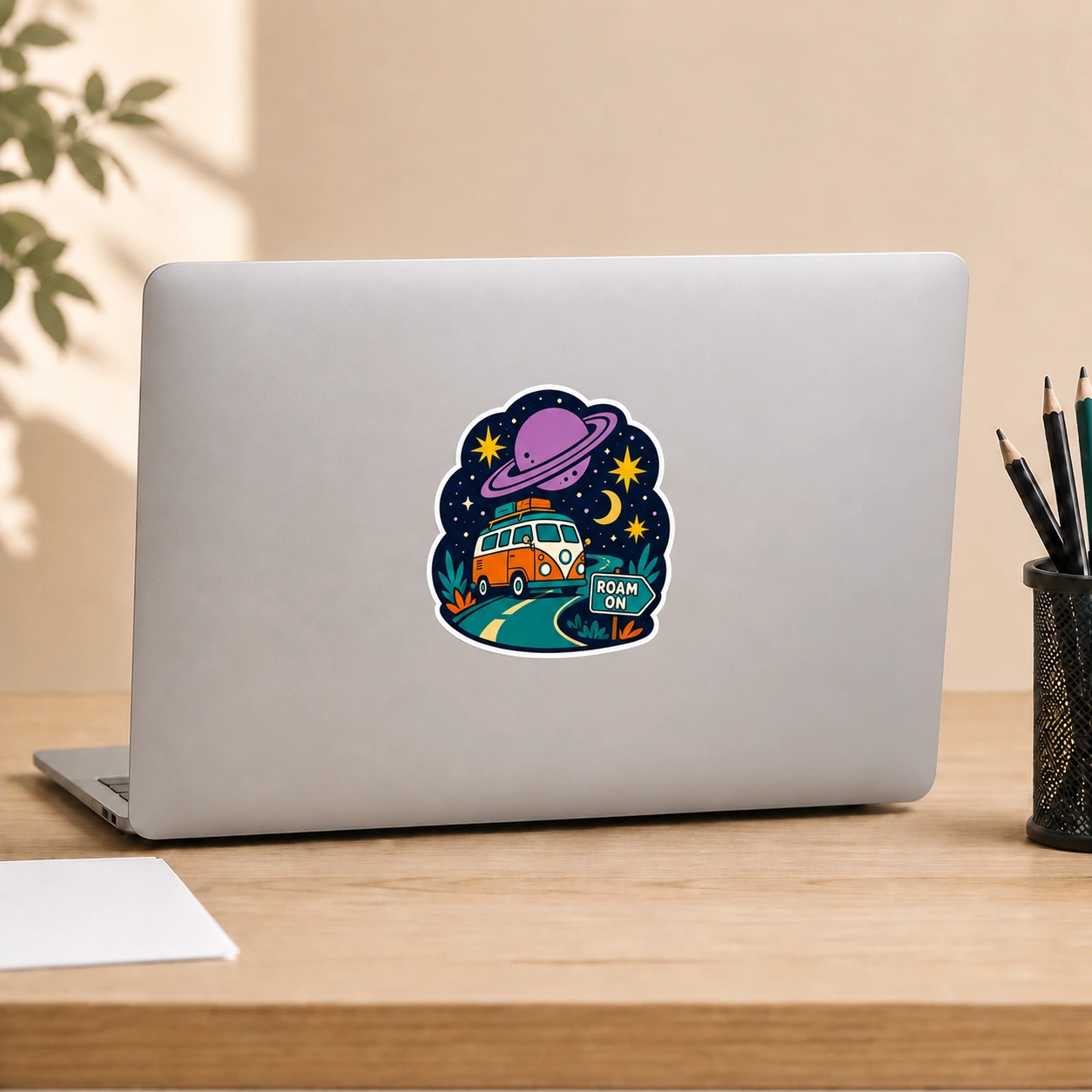 Starry Adventures Sticker, Roam On design shown on a laptop lid