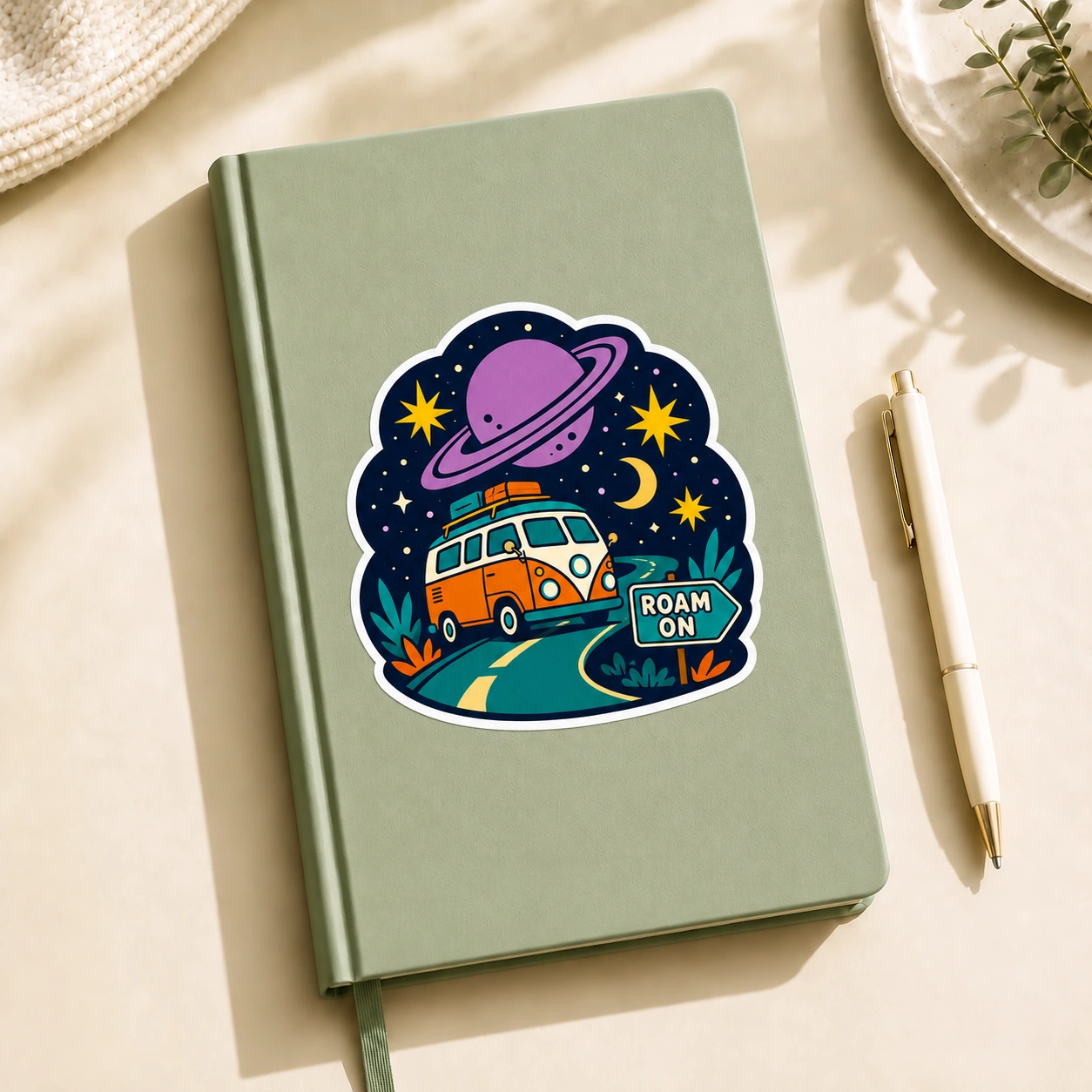 Starry Adventures Sticker, Roam On design shown on a notebook